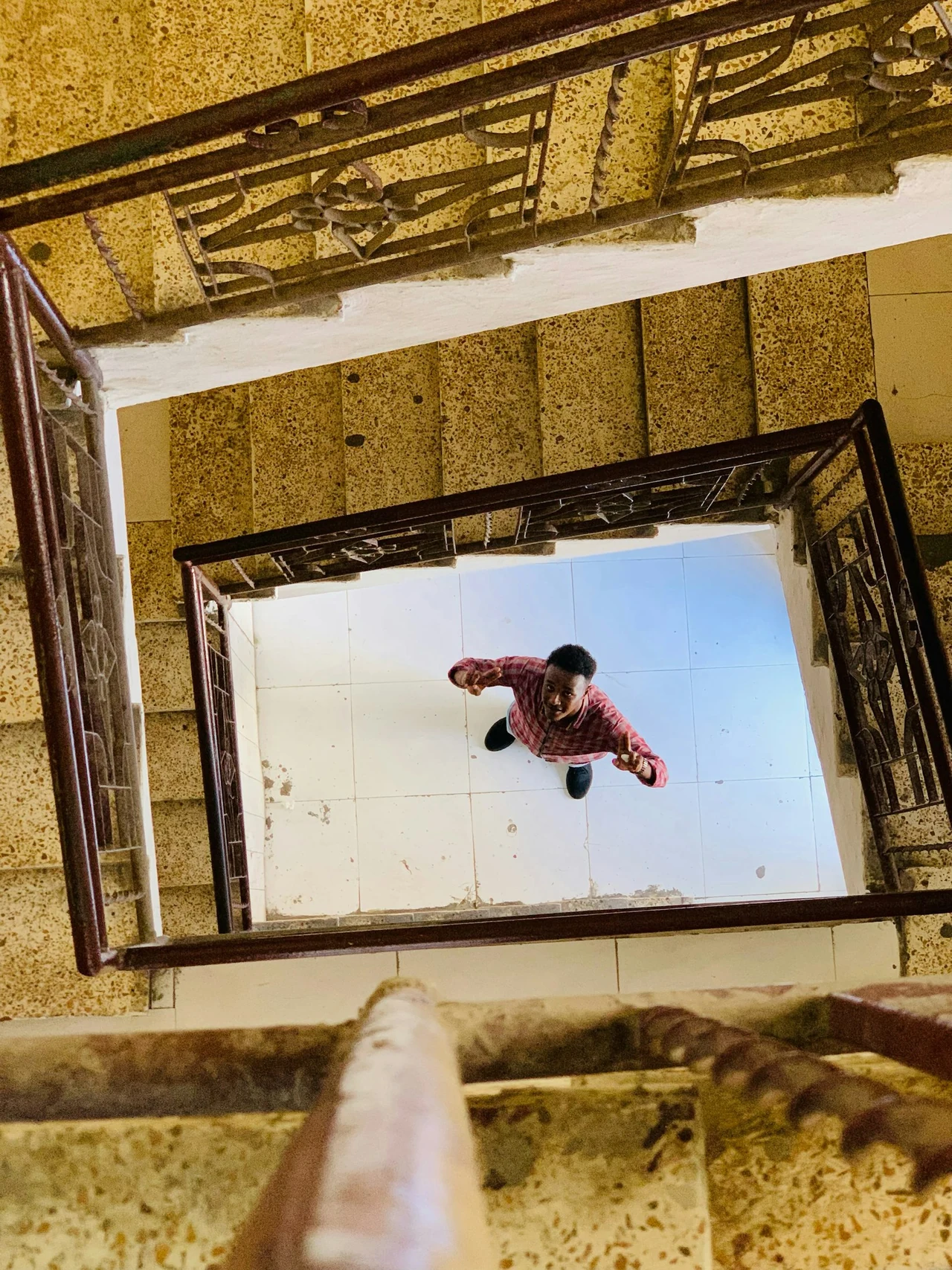 A view down through a square opening and surrounding structure.