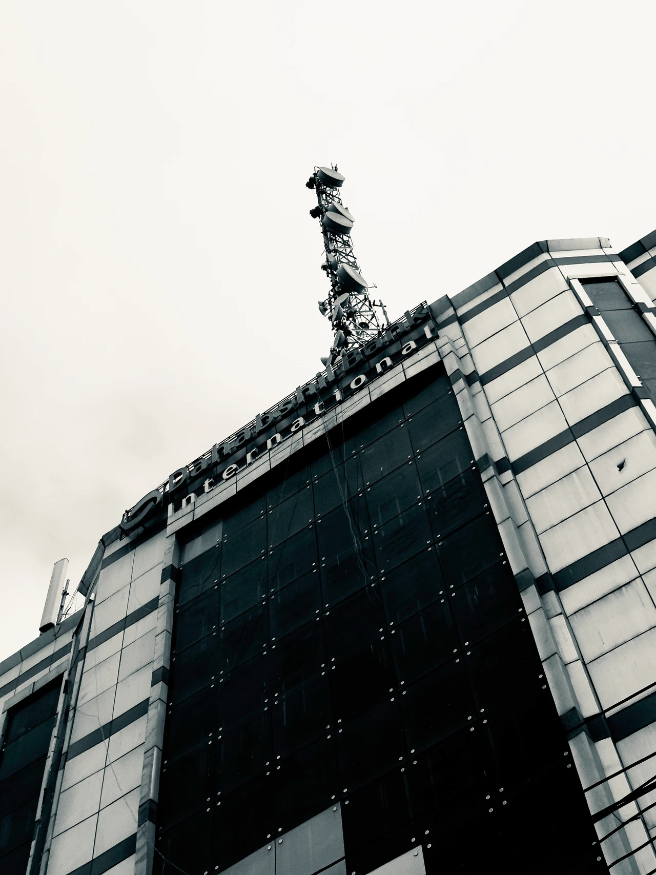 An upward view of the Dahabshiil Bank International building and rooftop antenna.
