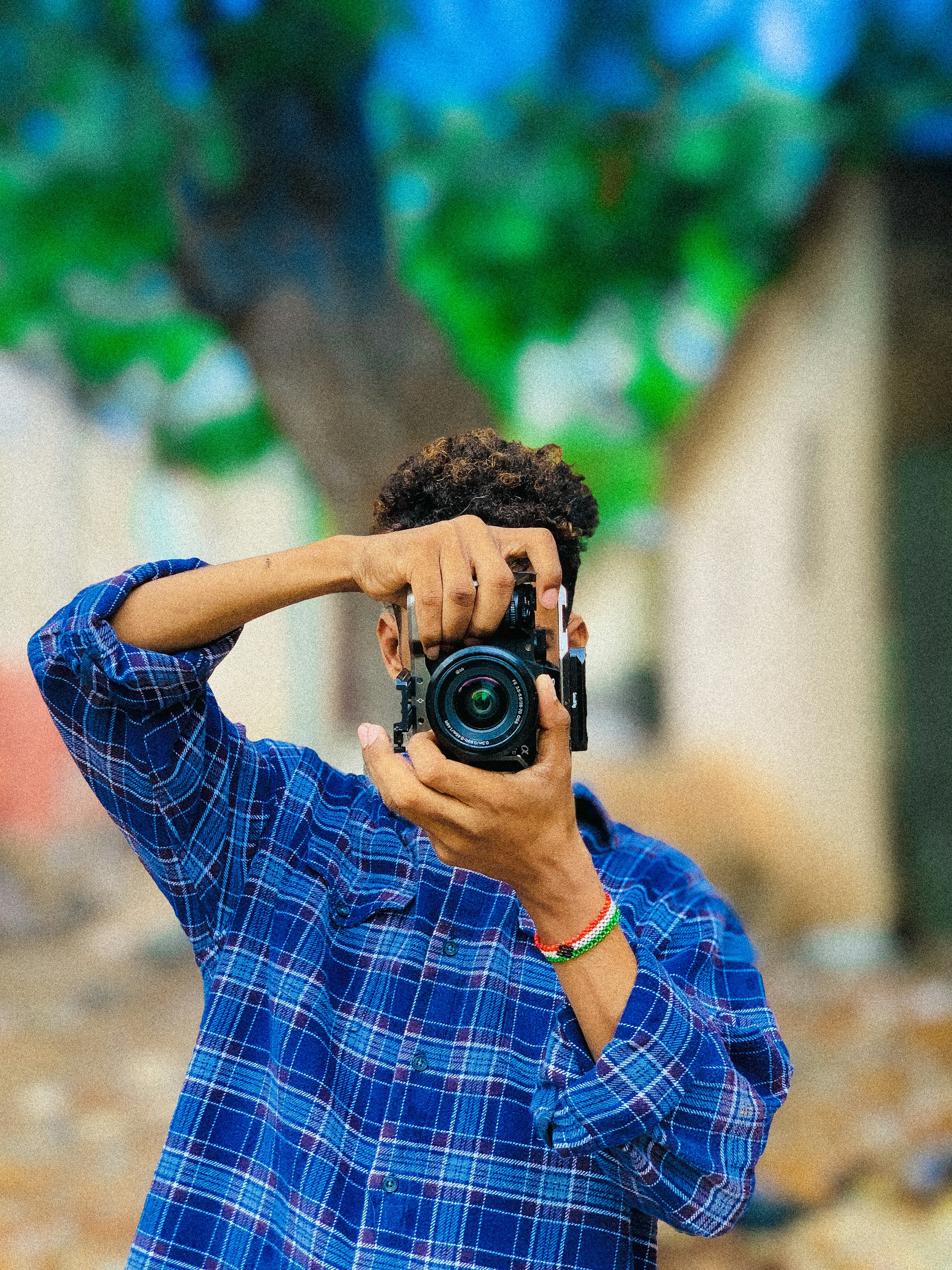 A self-portrait of a photographer in Mogadishu — camera raised, colors alive, and a quiet moment between the person seeing the world and the world seeing back.