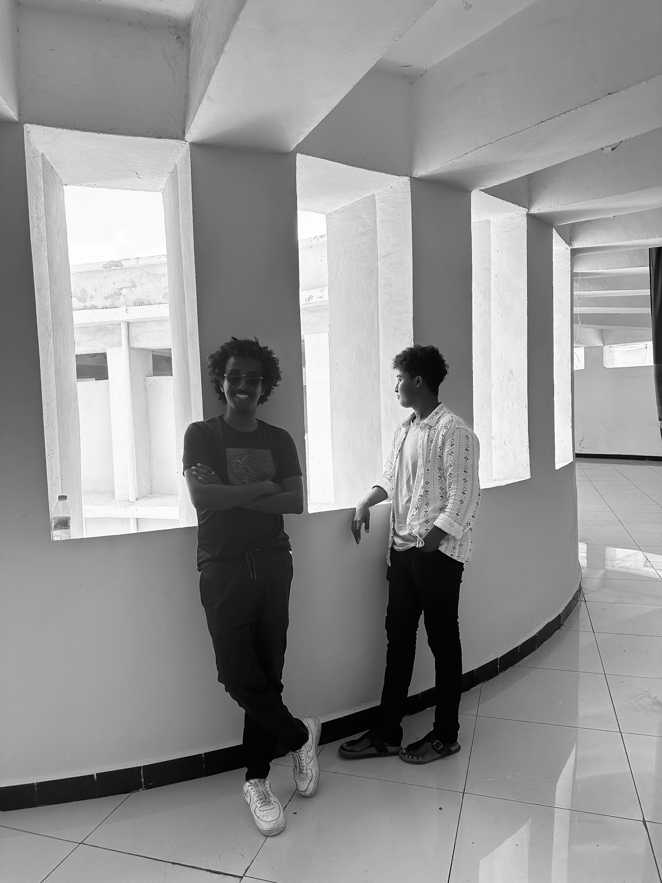 A quiet moment with my older brother in Mogadishu — standing in soft light, carrying the calm strength of someone who has always walked before me.